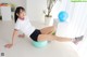 A woman is sitting on an exercise ball on the floor.