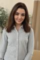 A woman in a striped shirt posing for a picture.