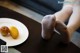 A plate of apples and a pair of white socks on a table.