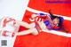 A woman laying on top of a red and white flag.